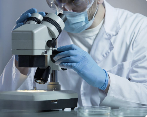 Researcher examining ethically sourced biologics through a microscope