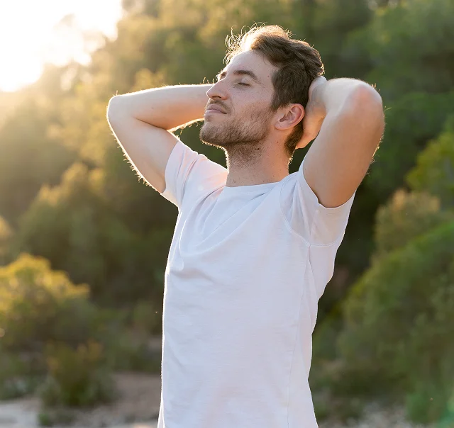 Man stretching outdoors as part of a healthy aging routine